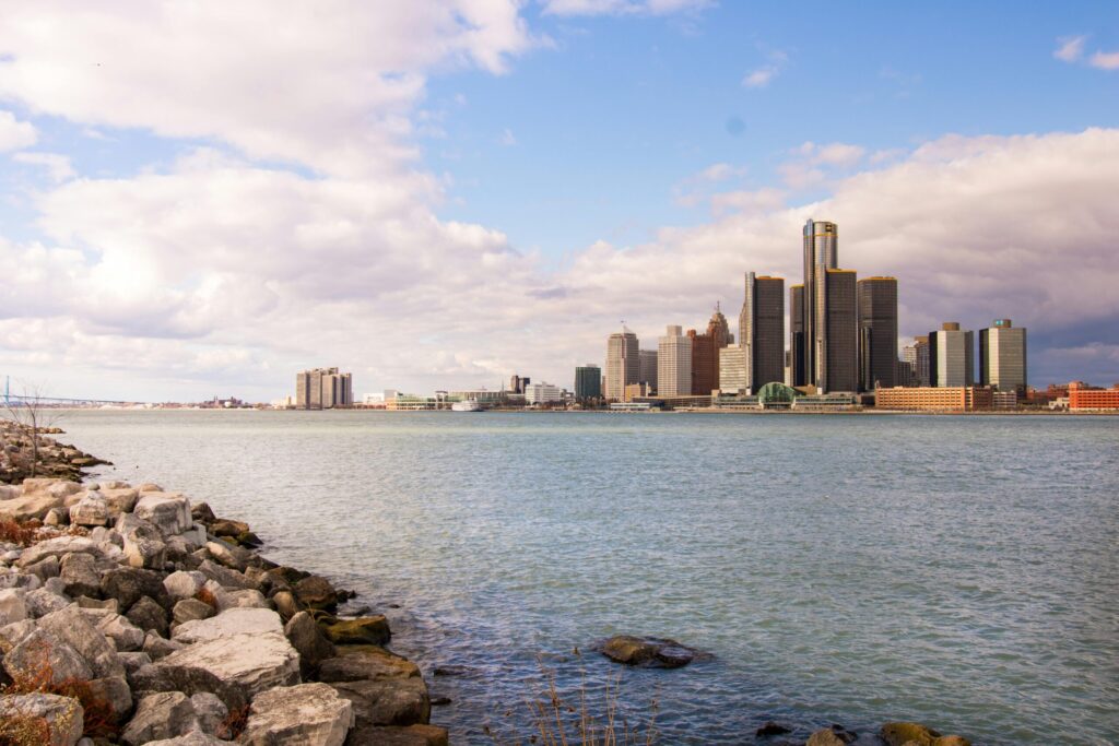 pexels-photo-702343-702343 View of the Detroit skyline across the river on a clear day with rock-strewn waterfront.